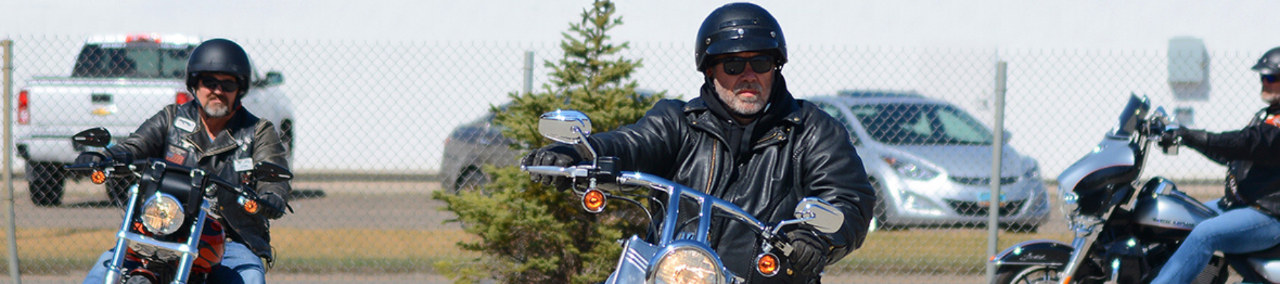 Three motorcyclists driving