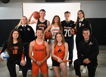 Group of students in their school colors posing for a photo