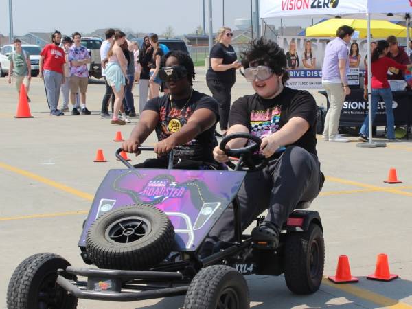 Young students driving a go-cart at a Vision Zero Event