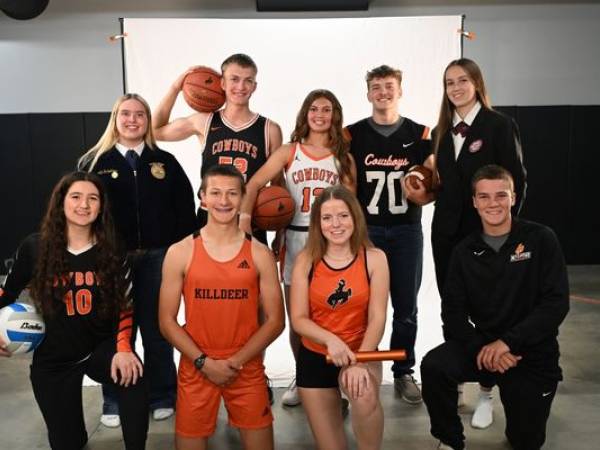 Group of students in their school colors posing for a photo