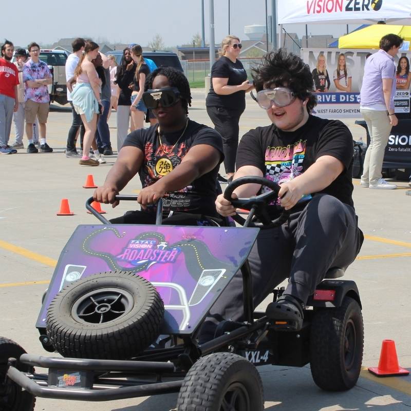 Young students driving a go-cart at a Vision Zero Event