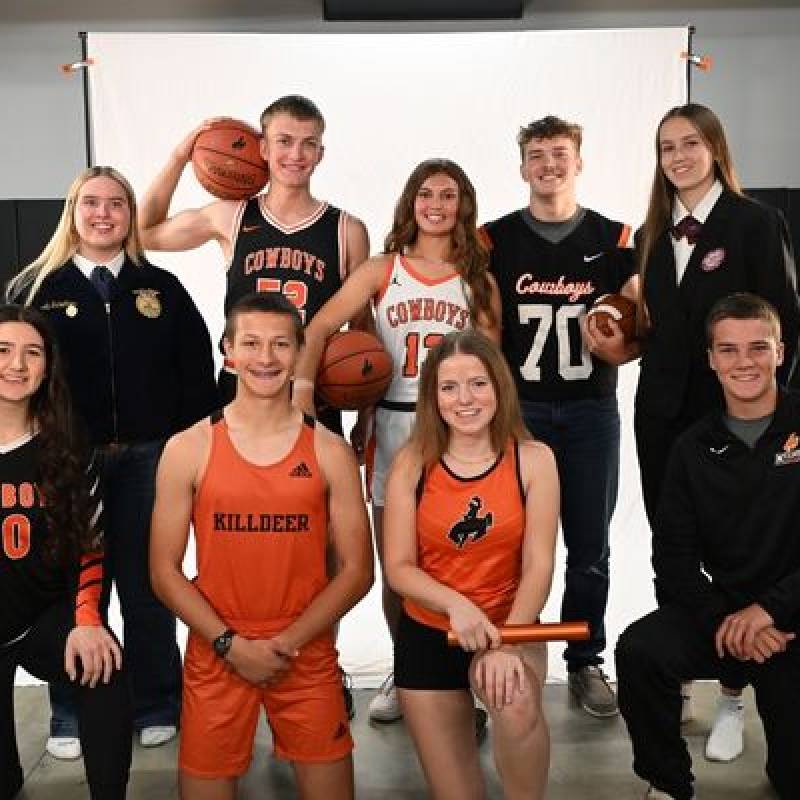 Group of students in their school colors posing for a photo